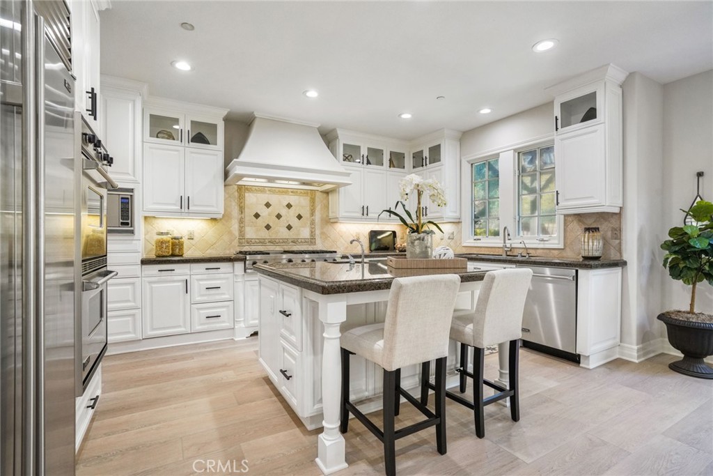 36 Blue Summit Irvine, CA 92603 - Photo 13 of 48 a kitchen with stainless steel appliances kitchen island granite countertop a sink and cabinets