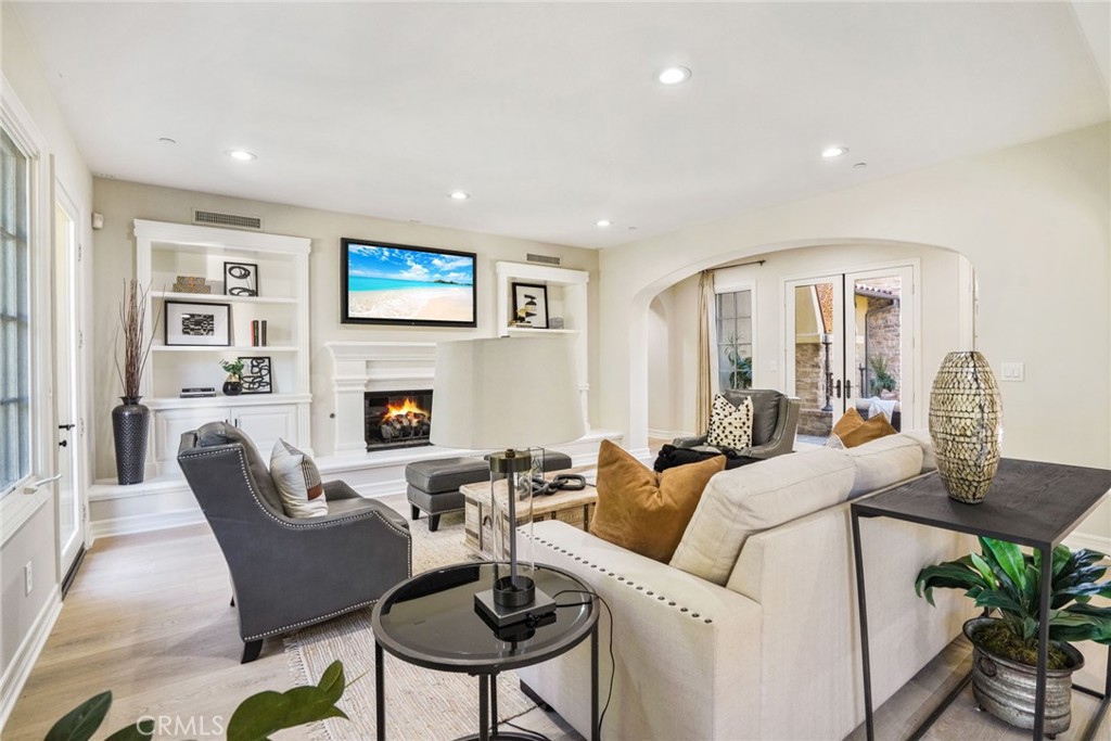 36 Blue Summit Irvine, CA 92603 - Photo 15 of 48 a living room with furniture a fireplace and a flat screen tv