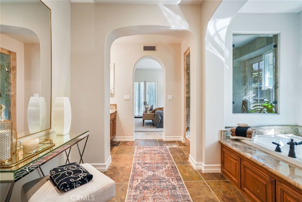 36 Blue Summit Irvine, CA 92603 - Photo 23 of 48 a view of a hallway with wooden floor and a rug