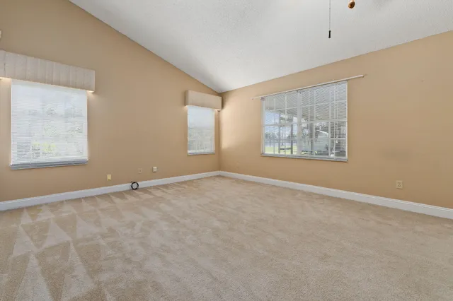 an empty room with windows and closet