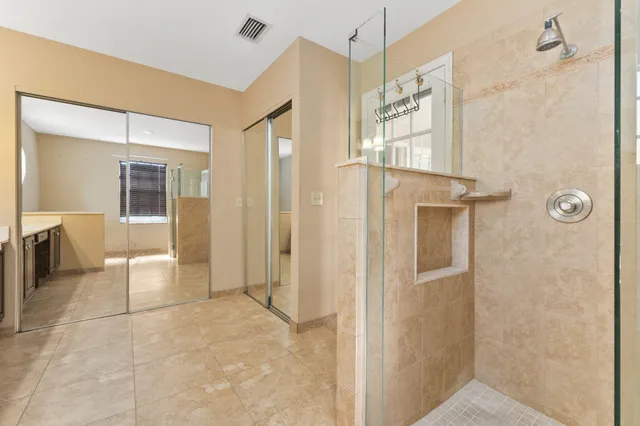 a bathroom with a glass shower door and a shower