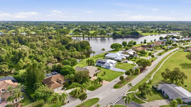 an aerial view of a houses with a lake view