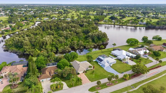 an aerial view of a house with a lake view