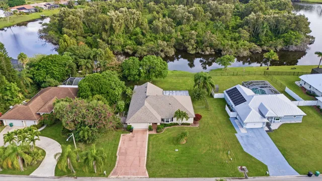 an aerial view of a house with garden space and ocean view