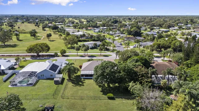 an aerial view of residential houses with outdoor space and swimming pool