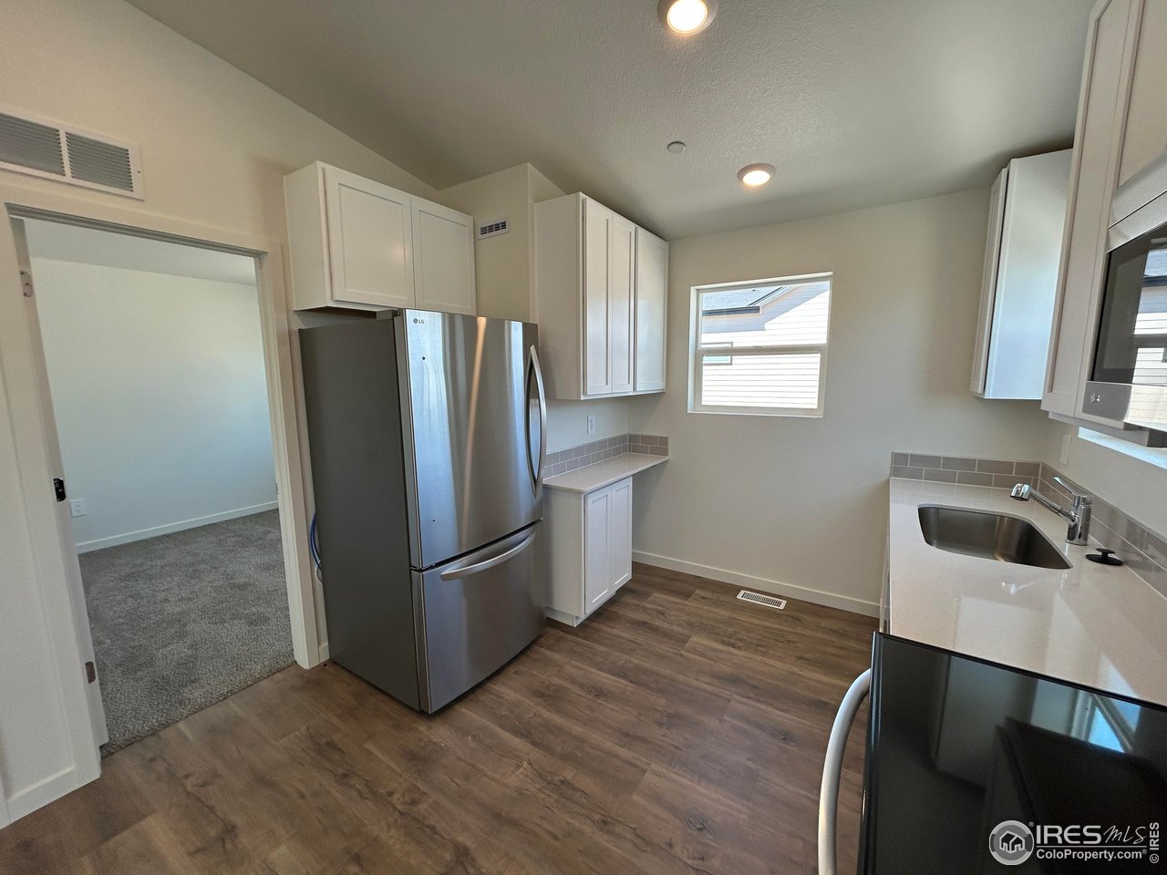 3716 Pinnacles Court Evans, CO 80620 - Photo 5 of 9 a kitchen with stainless steel appliances a refrigerator and a sink