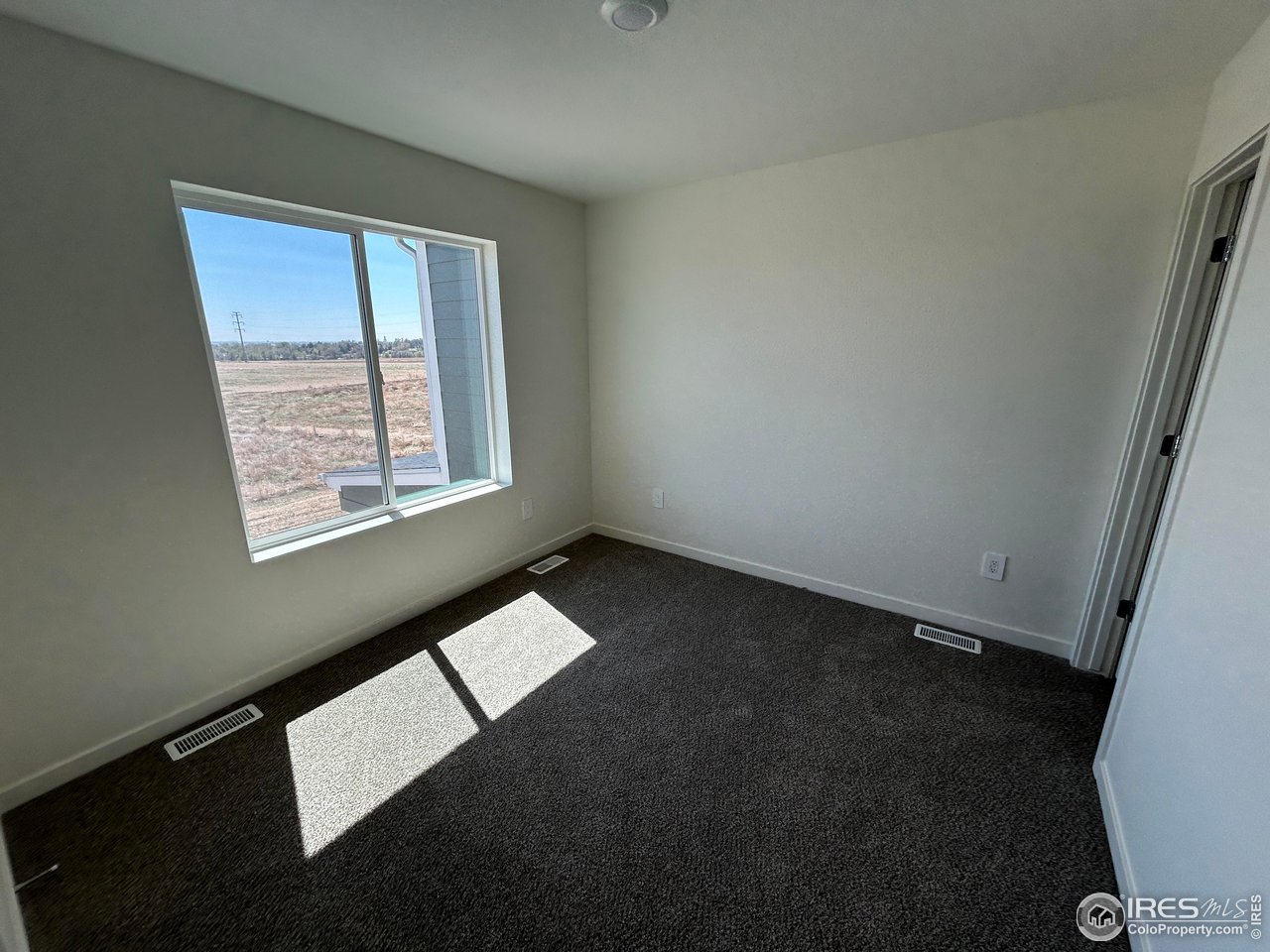 3716 Pinnacles Court Evans, CO 80620 - Photo 7 of 9 an empty room with a window