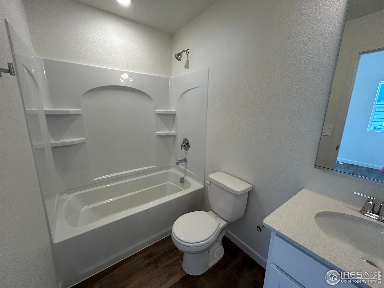 3716 Pinnacles Court Evans, CO 80620 - Photo 8 of 9 a bathroom with a sink toilet and shower