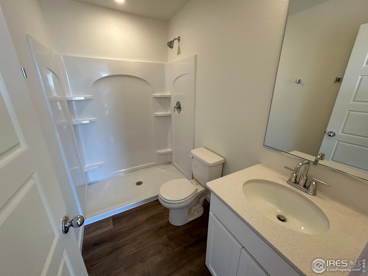 3716 Pinnacles Court Evans, CO 80620 - Photo 9 of 9 a bathroom with a sink a toilet and shower