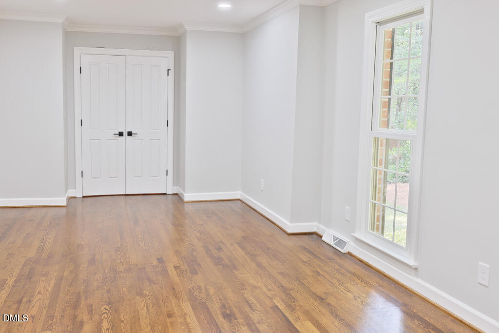 14263 Wyndfield Circle Raleigh, NC 27615 - Photo 29 of 74 a view of an empty room with wooden floor and a window