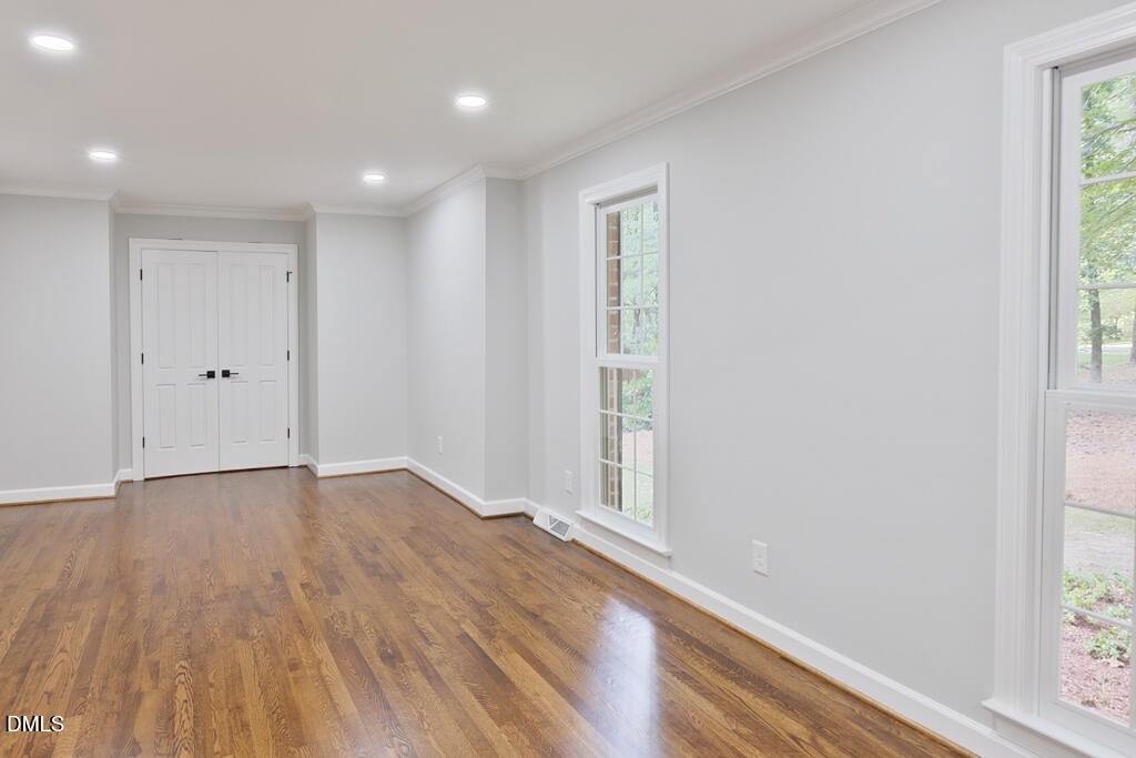 14263 Wyndfield Circle Raleigh, NC 27615 - Photo 30 of 74 an empty room with wooden floor and windows