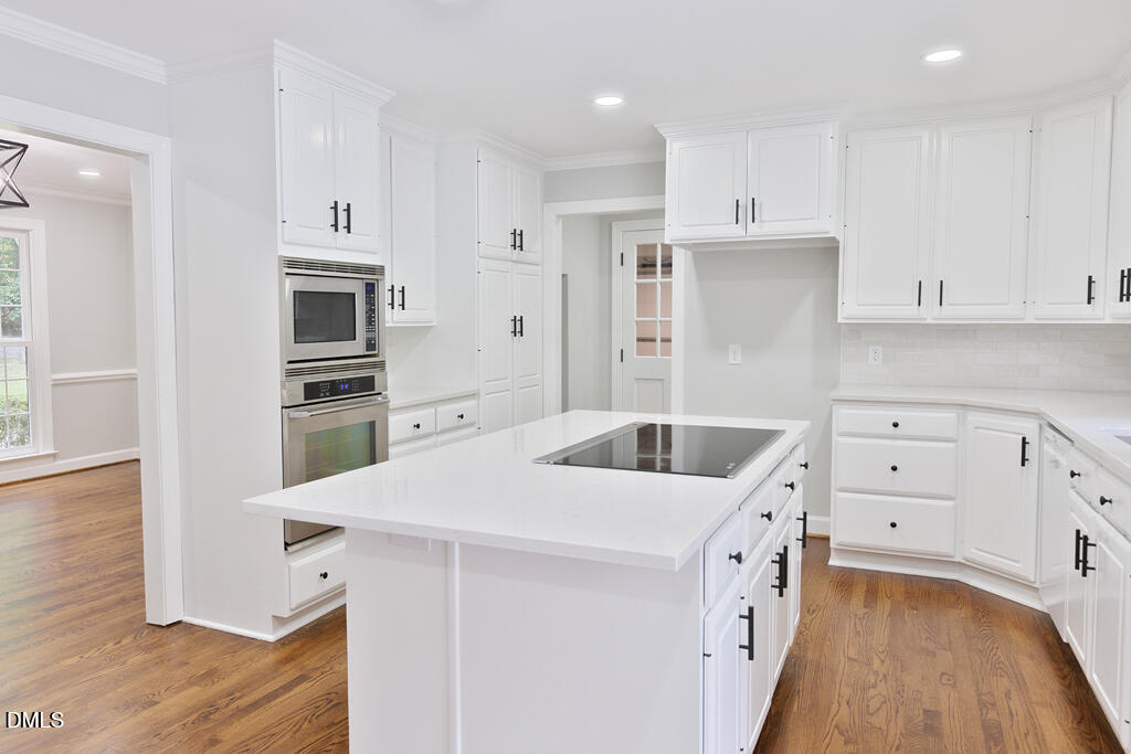 14263 Wyndfield Circle Raleigh, NC 27615 - Photo 34 of 74 a kitchen that has a cabinets and a stove