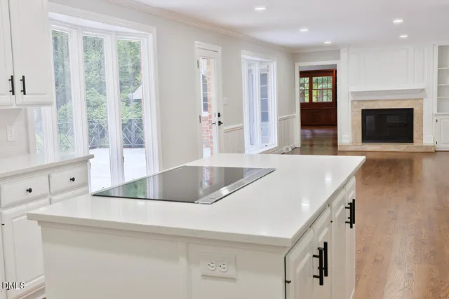 an empty room with wooden floor and a window