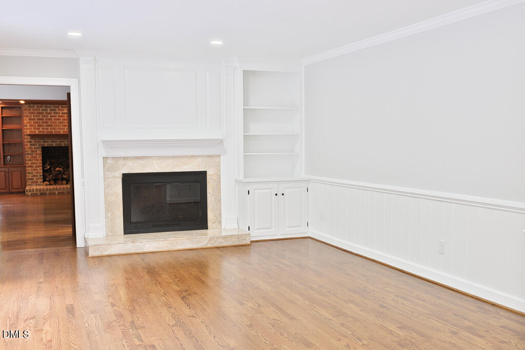 14263 Wyndfield Circle Raleigh, NC 27615 - Photo 39 of 74 an empty room with wooden floor and fireplace