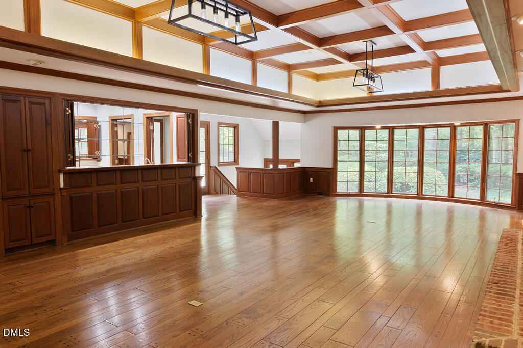 14263 Wyndfield Circle Raleigh, NC 27615 - Photo 44 of 74 a view of an empty room with wooden floor and furniture
