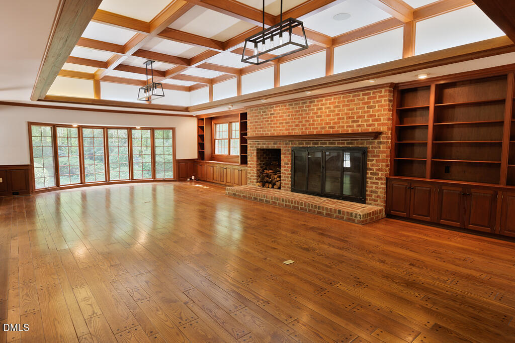 14263 Wyndfield Circle Raleigh, NC 27615 - Photo 45 of 74 an empty room with wooden floor fireplace and windows