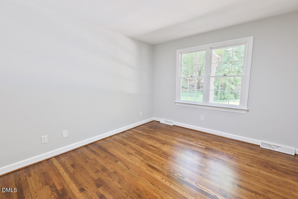 14263 Wyndfield Circle Raleigh, NC 27615 - Photo 49 of 74 a view of an empty room with wooden floor and a window