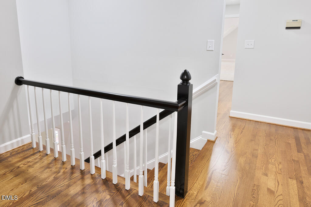 14263 Wyndfield Circle Raleigh, NC 27615 - Photo 52 of 74 a view of staircase with railing and white walls