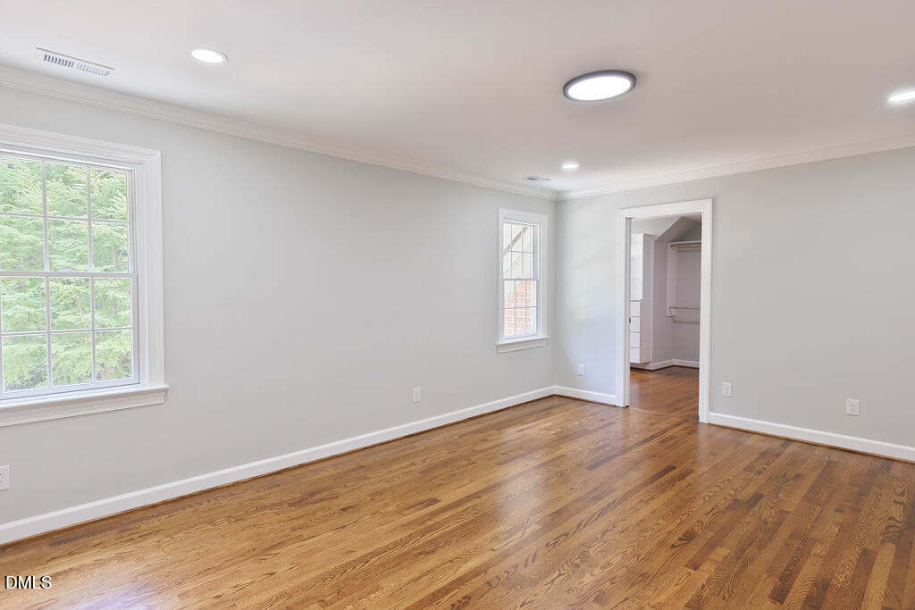 14263 Wyndfield Circle Raleigh, NC 27615 - Photo 53 of 74 an empty room with wooden floor and windows