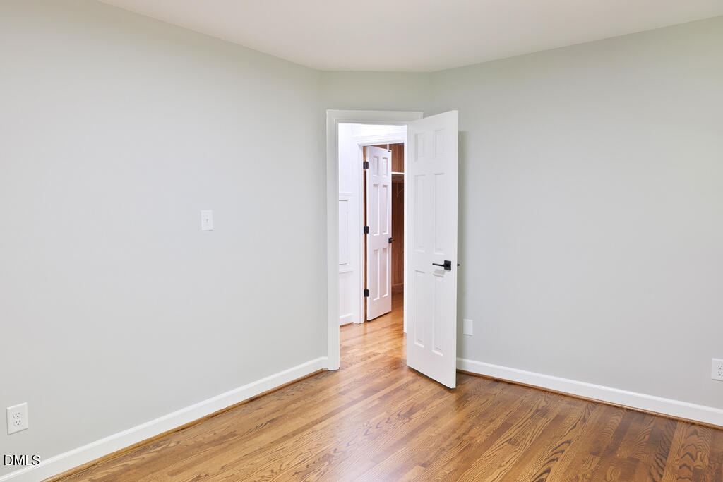 14263 Wyndfield Circle Raleigh, NC 27615 - Photo 60 of 74 a view of an empty room with wooden floor and closet