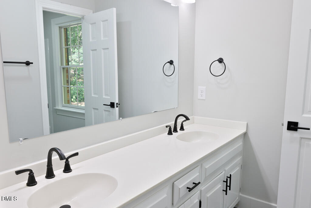 14263 Wyndfield Circle Raleigh, NC 27615 - Photo 62 of 74 a bathroom with a sink and a mirror