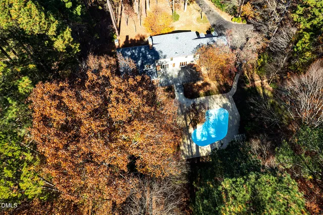 a front view of a house with garden and tree