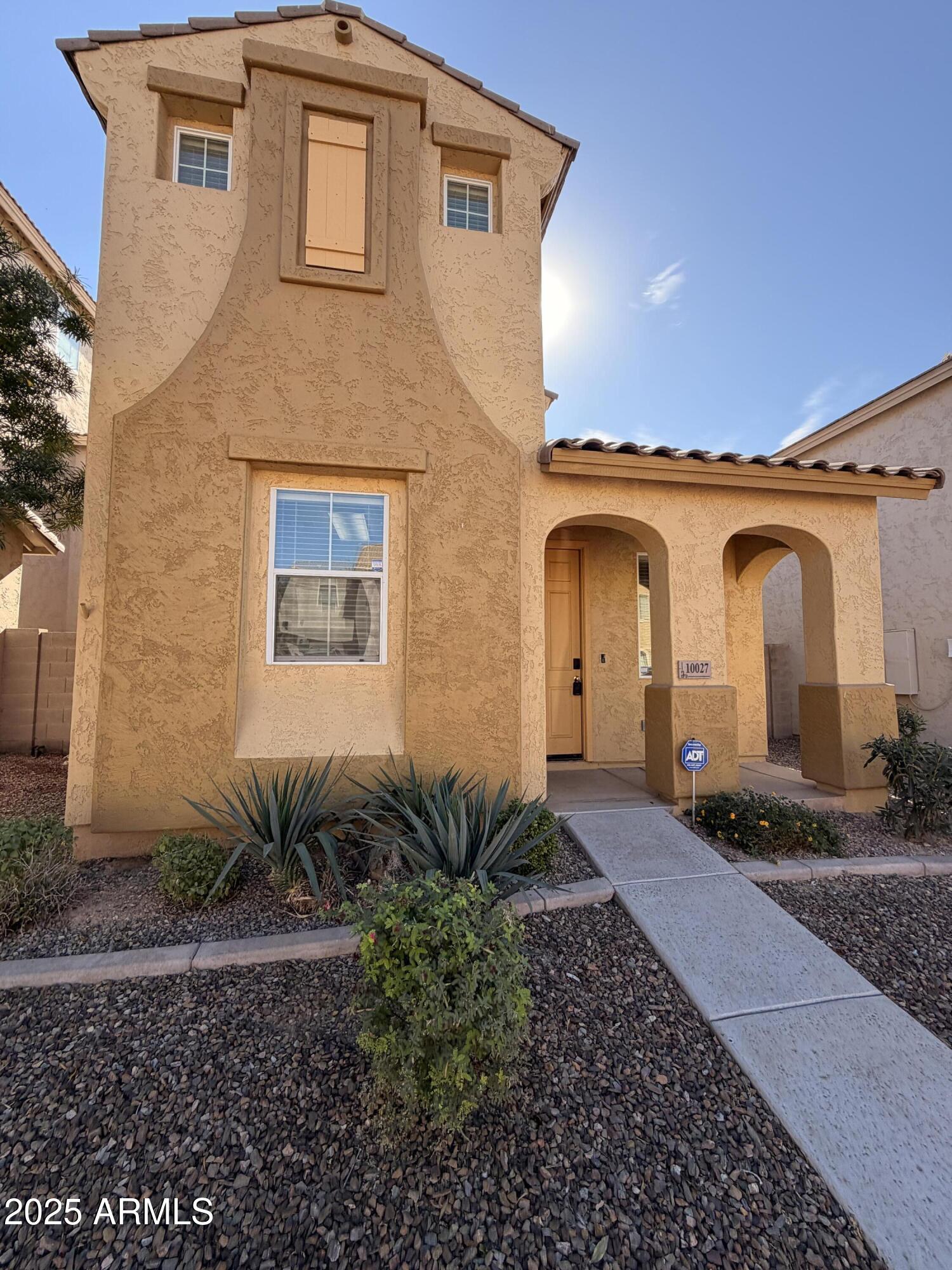 10027 West Payson Road Tolleson, AZ 85353 - Photo 1 of 18 a front view of a house with garden