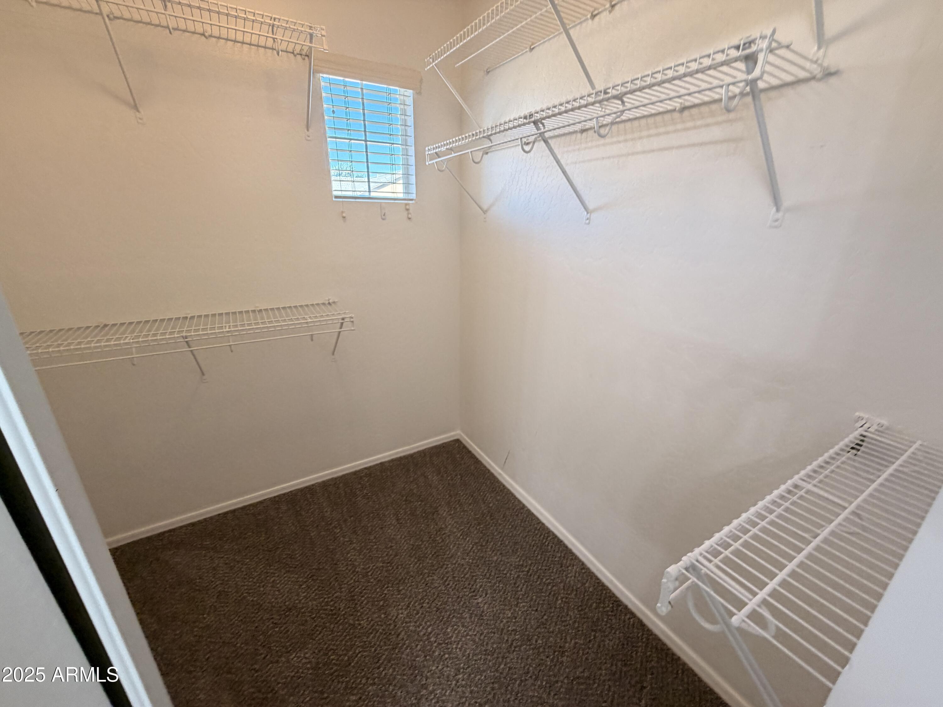 10027 West Payson Road Tolleson, AZ 85353 - Photo 11 of 18 a view of a room with racks on the wall