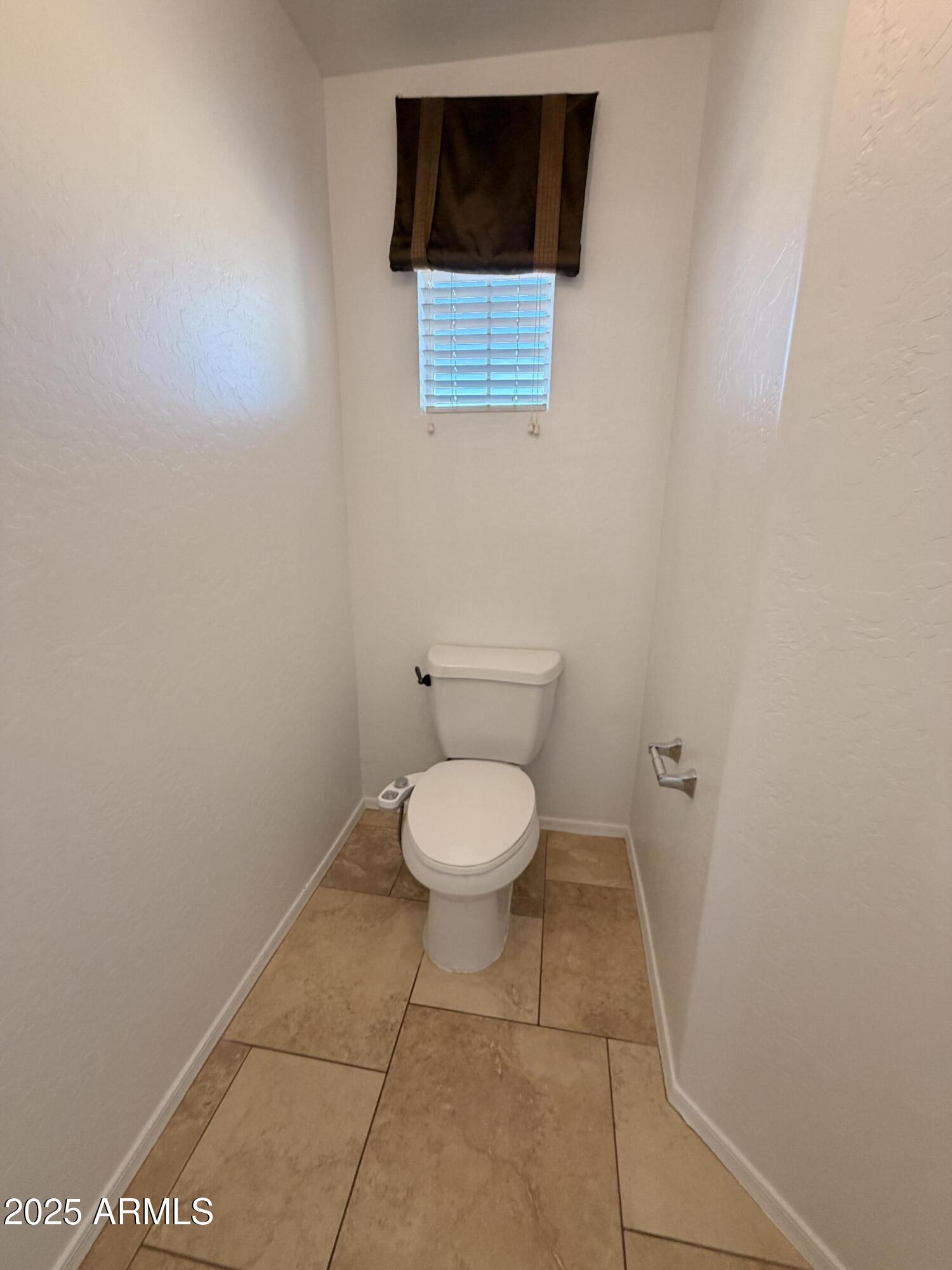 10027 West Payson Road Tolleson, AZ 85353 - Photo 12 of 18 a bathroom with a toilet