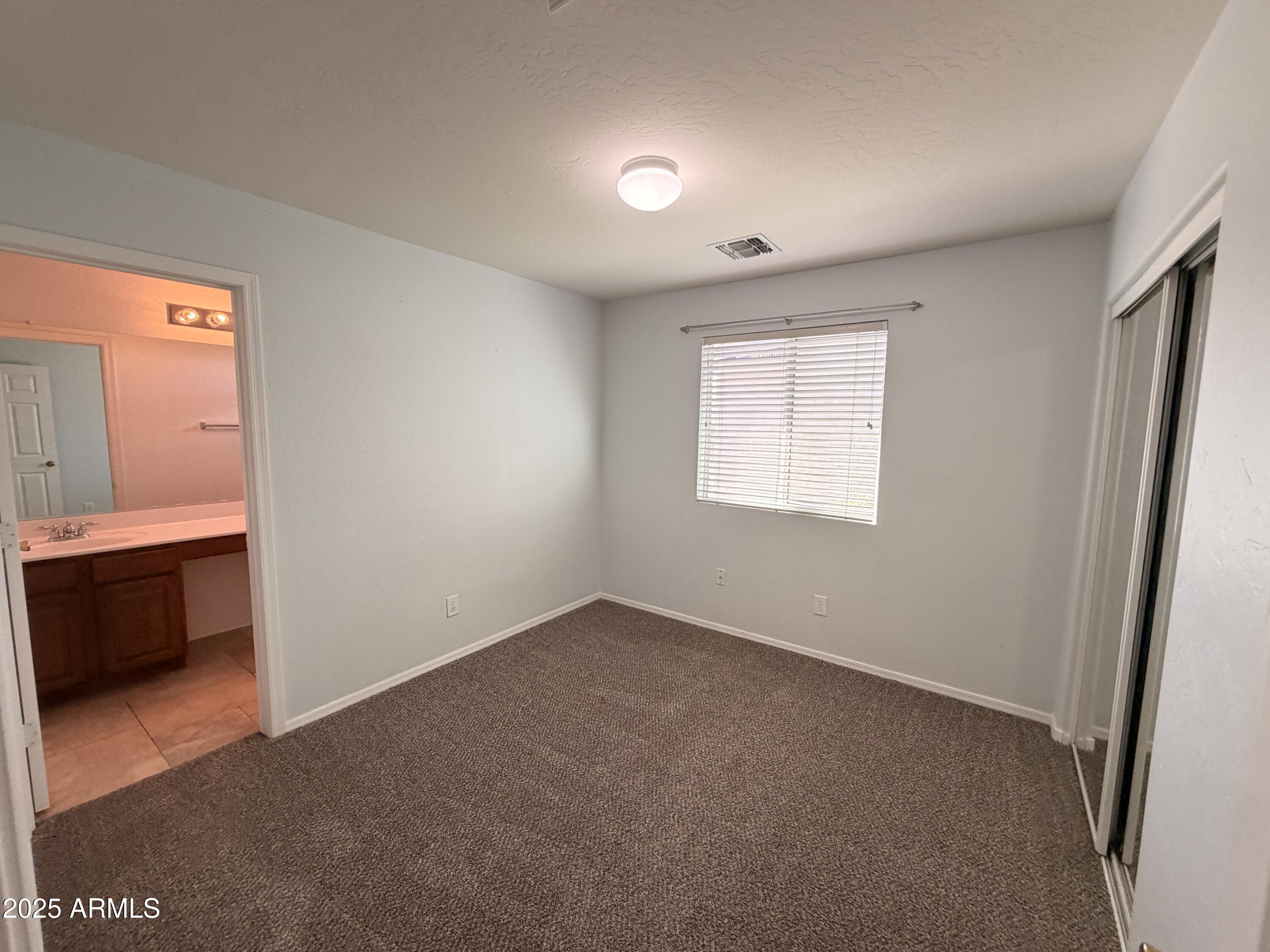 10027 West Payson Road Tolleson, AZ 85353 - Photo 13 of 18 an empty room with windows