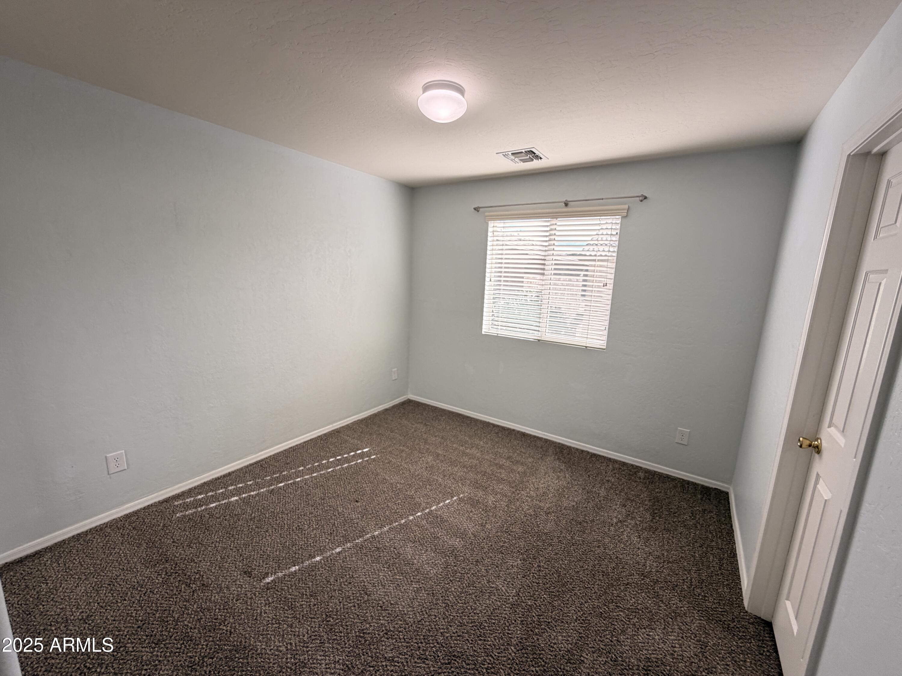 10027 West Payson Road Tolleson, AZ 85353 - Photo 14 of 18 an empty room with a window