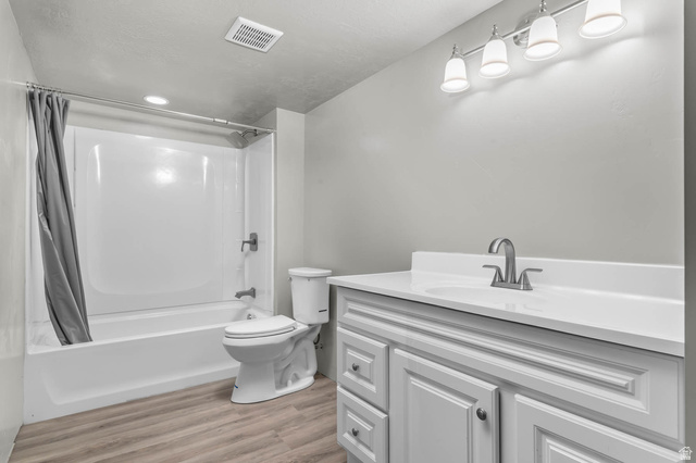 5686 Duke Lane Tooele, UT 84074 - Photo 37 of 38 Full bath featuring vanity, shower / bath combo with shower curtain, and light wood-style flooring