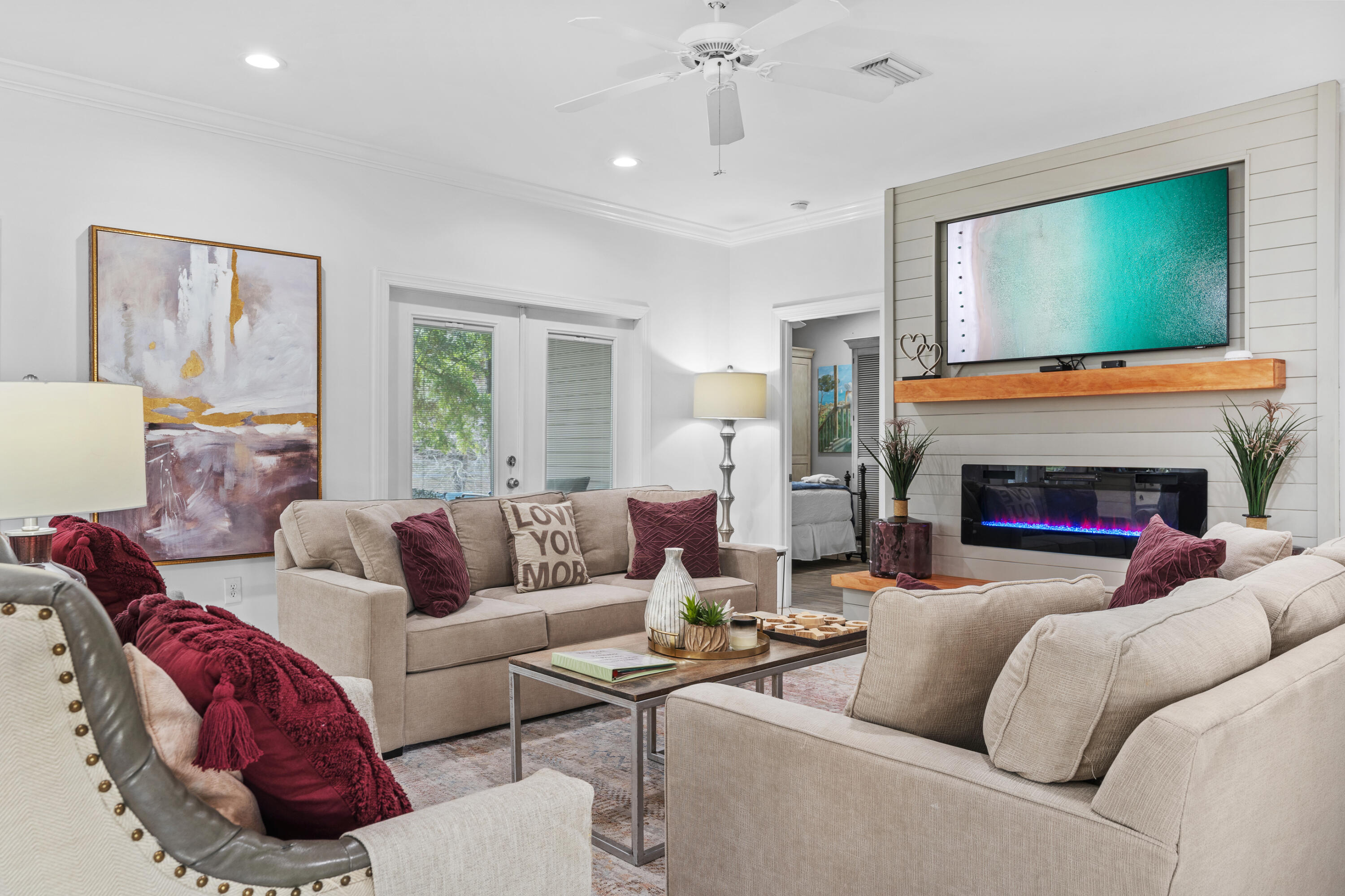 Undisclosed Address Miramar Beach, FL 32550 - Photo 2 of 51 a living room with furniture a flat screen tv and a fireplace