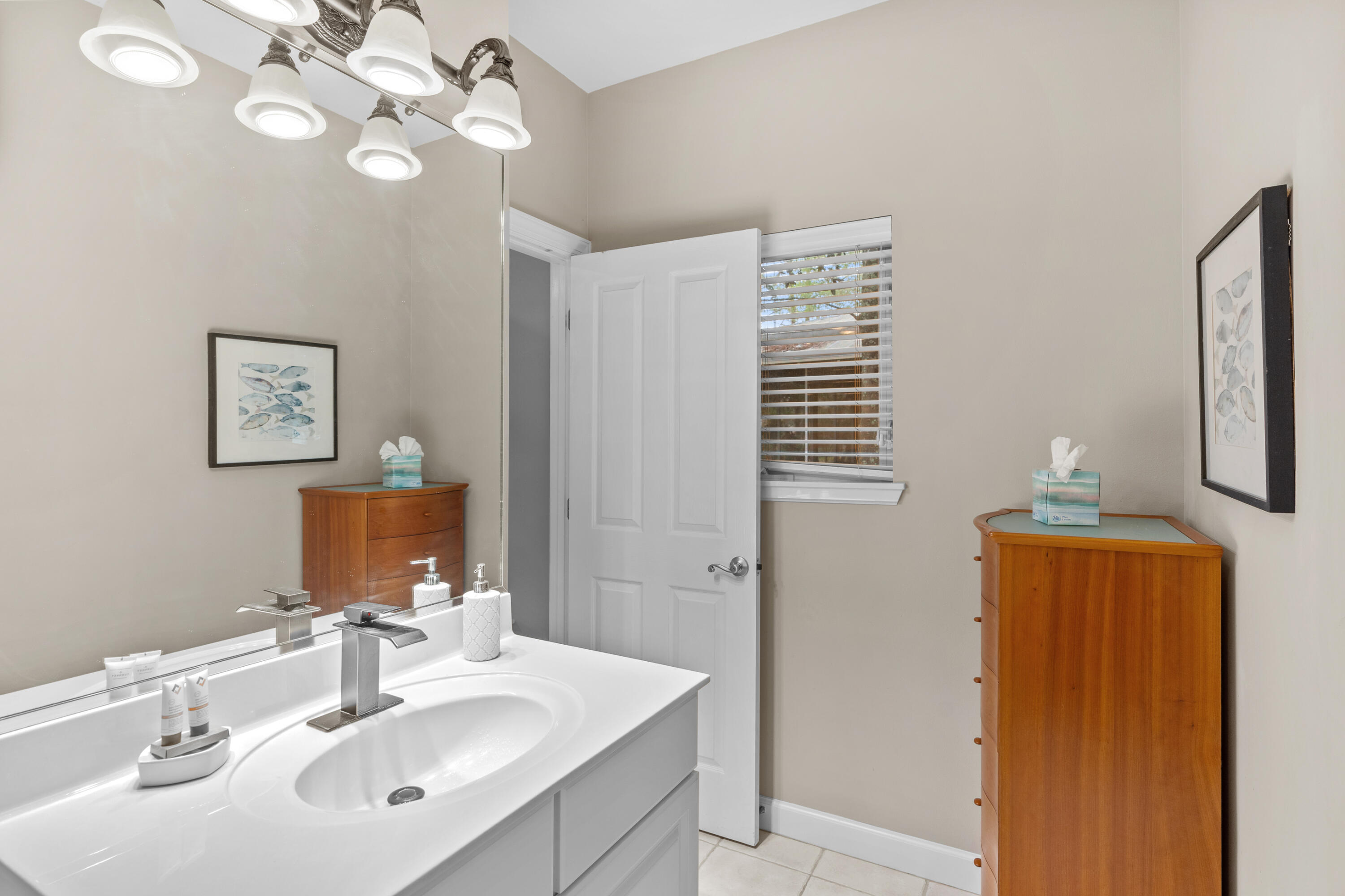 Undisclosed Address Miramar Beach, FL 32550 - Photo 24 of 51 a bathroom with a sink a light fixture and a mirror