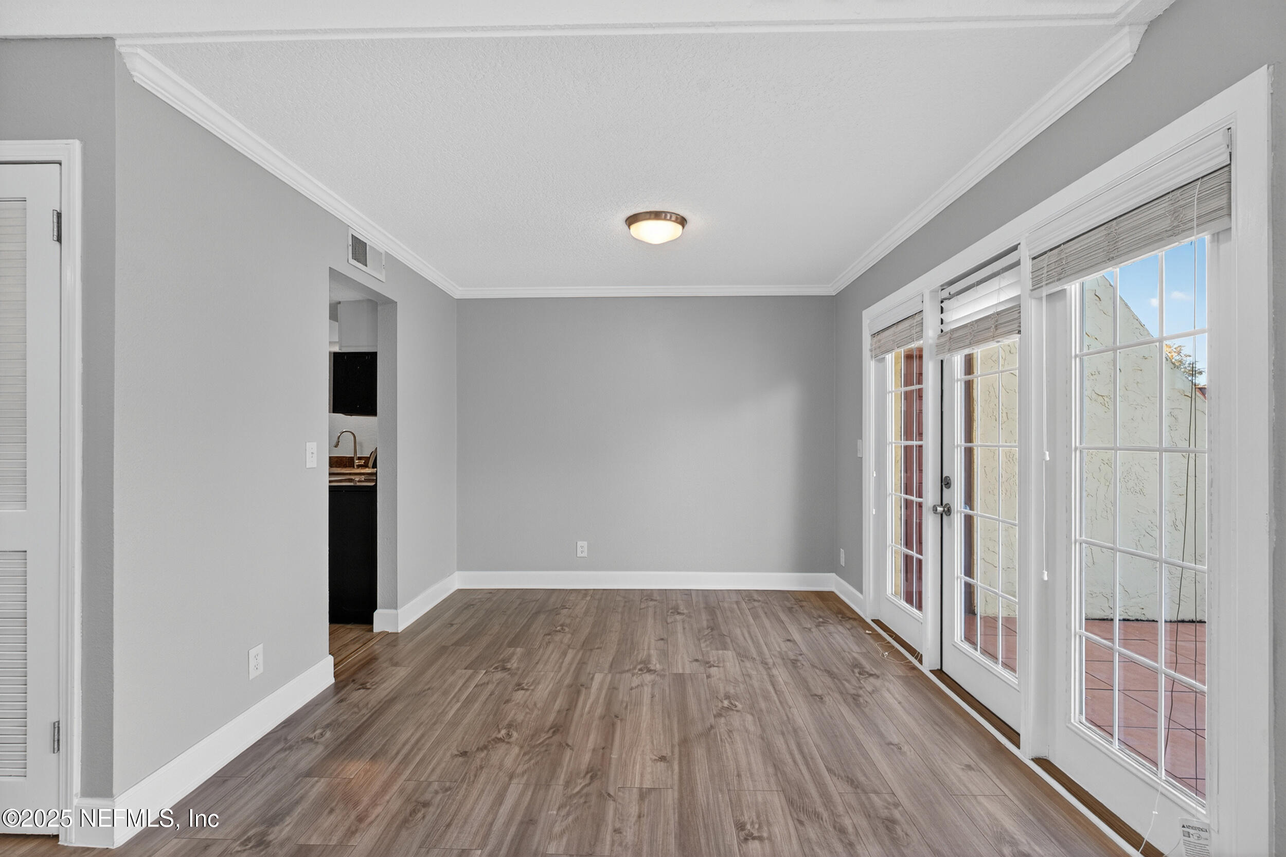 3913 Mission Drive, Unit 4 Jacksonville, FL 32217 - Photo 12 of 26 wooden floor in an empty room with a window