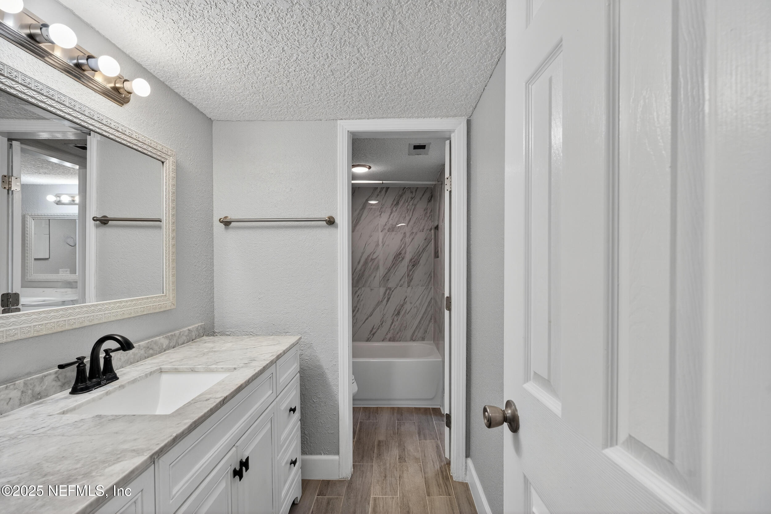 3913 Mission Drive, Unit 4 Jacksonville, FL 32217 - Photo 14 of 26 a bathroom with a granite countertop sink a mirror and shower
