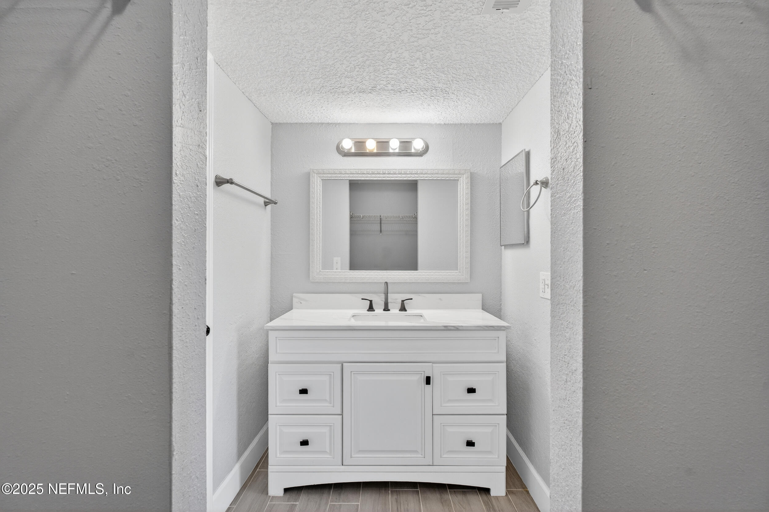 3913 Mission Drive, Unit 4 Jacksonville, FL 32217 - Photo 20 of 26 a bathroom with a sink and a mirror