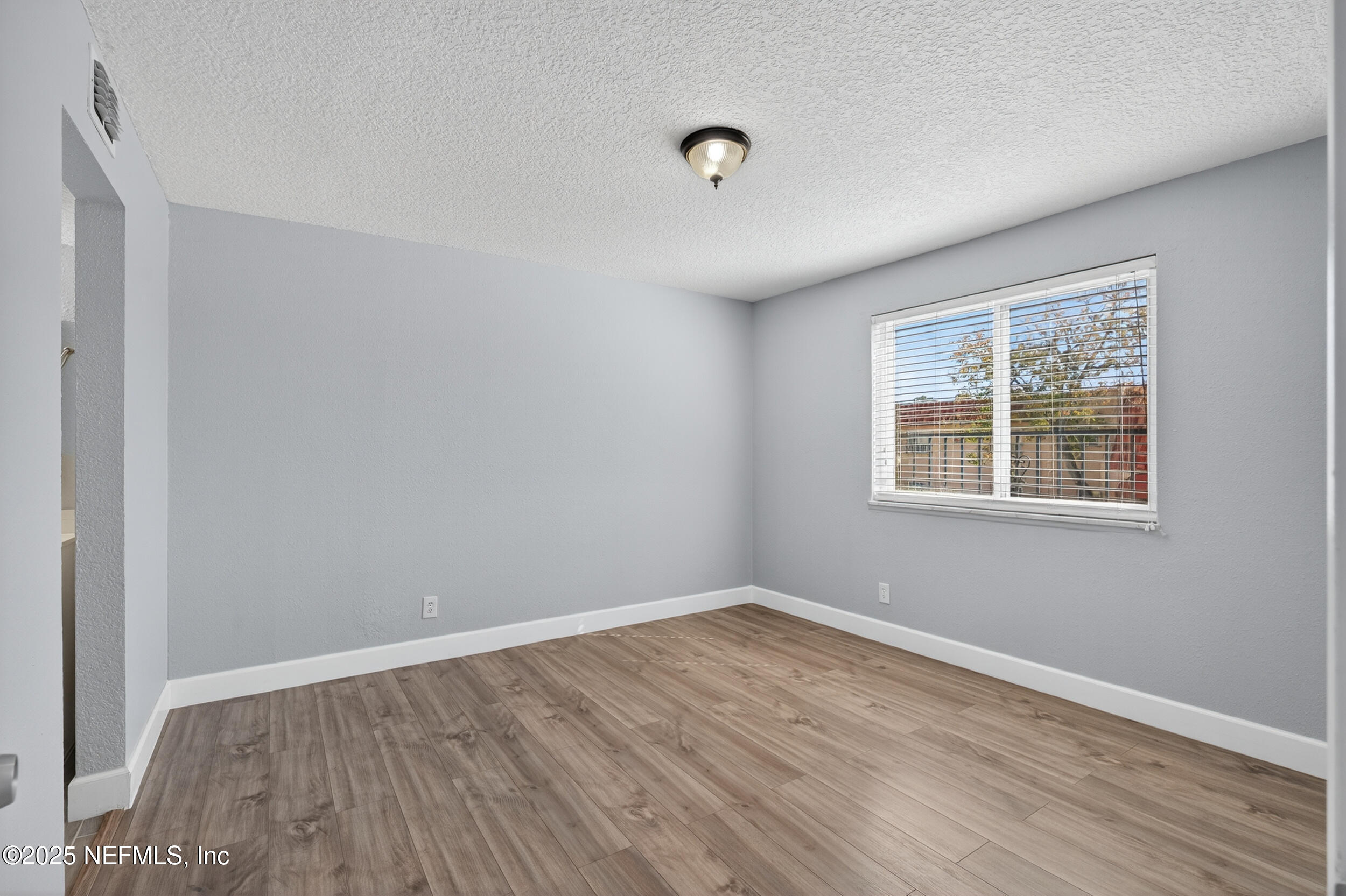 3913 Mission Drive, Unit 4 Jacksonville, FL 32217 - Photo 21 of 26 wooden floor in an empty room with a window