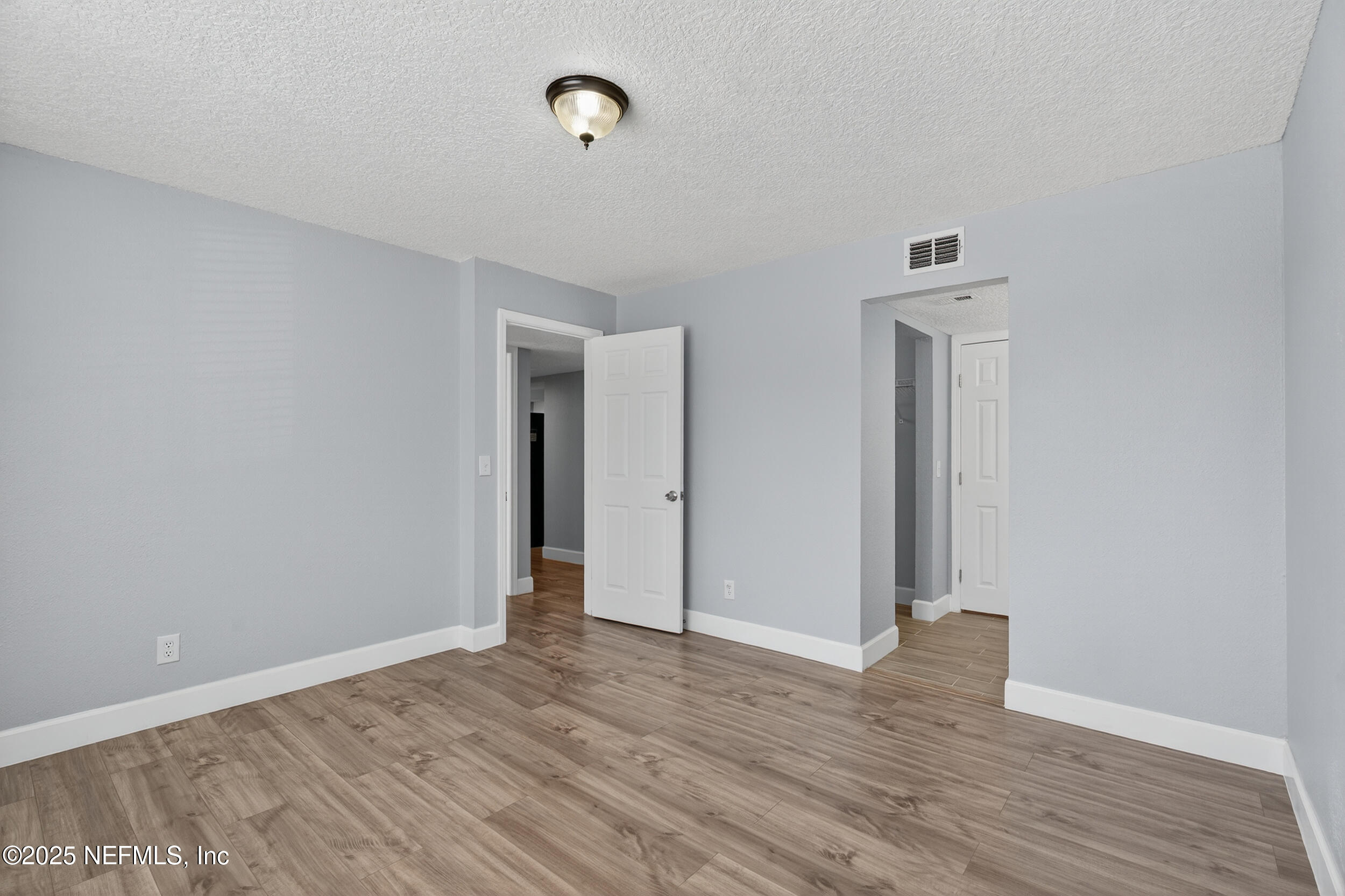 3913 Mission Drive, Unit 4 Jacksonville, FL 32217 - Photo 22 of 26 a view of an empty room with wooden floor and closet