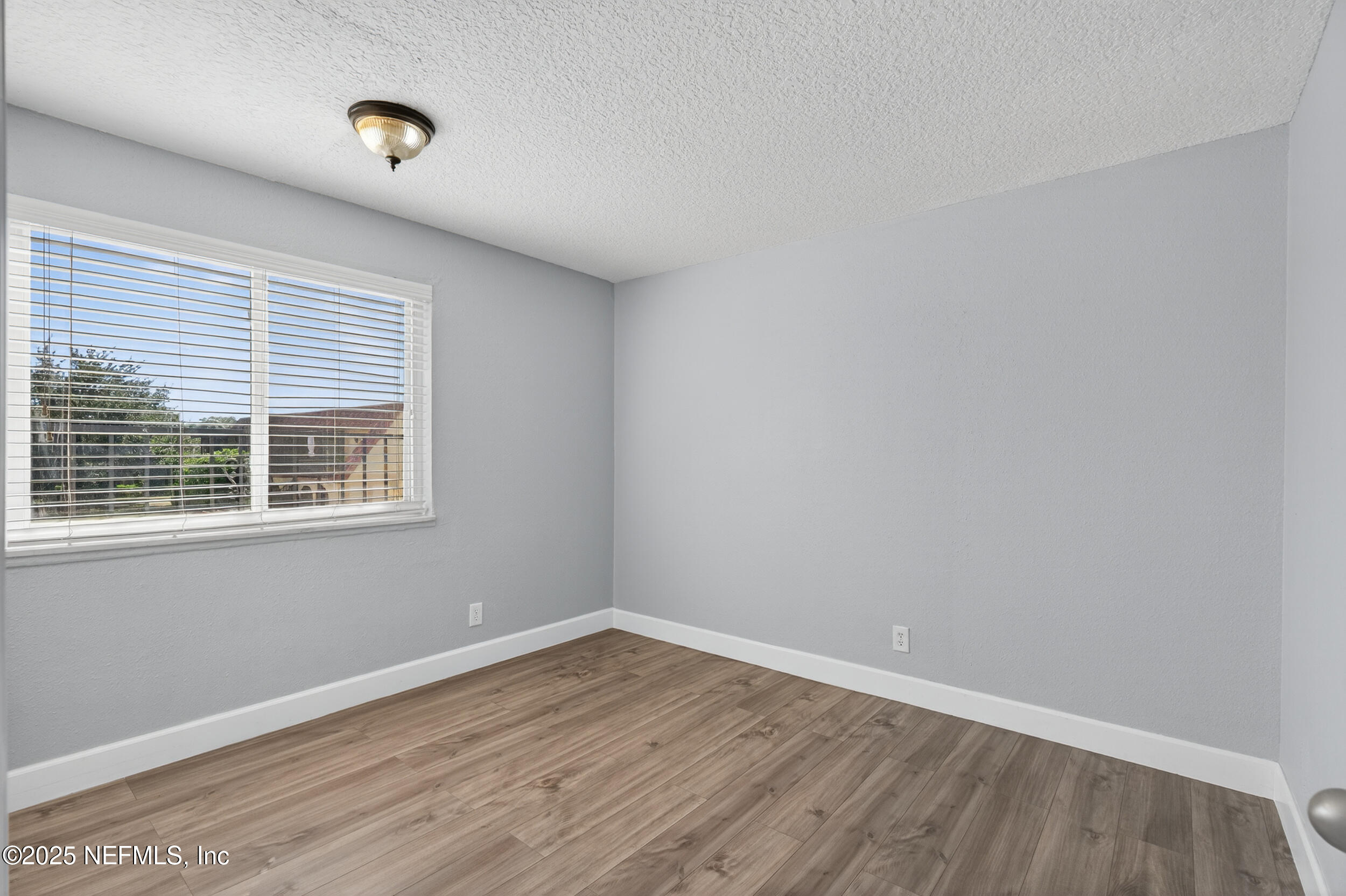 3913 Mission Drive, Unit 4 Jacksonville, FL 32217 - Photo 23 of 26 wooden floor in an empty room with a window