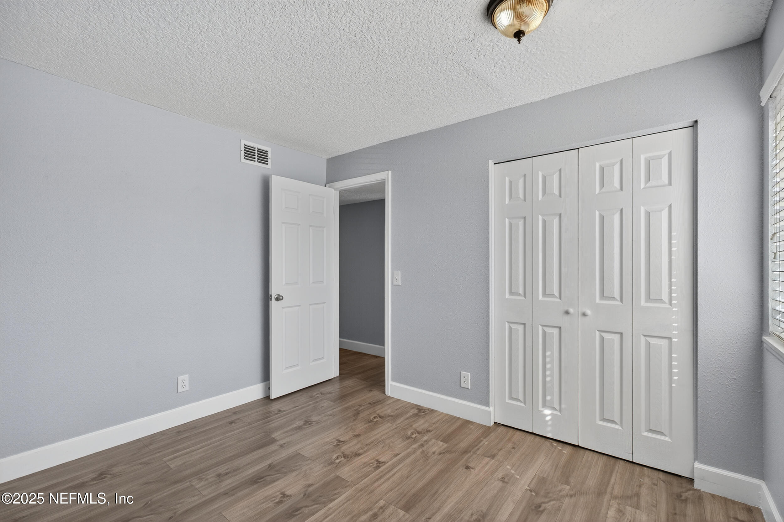 3913 Mission Drive, Unit 4 Jacksonville, FL 32217 - Photo 24 of 26 an empty room with wooden floor