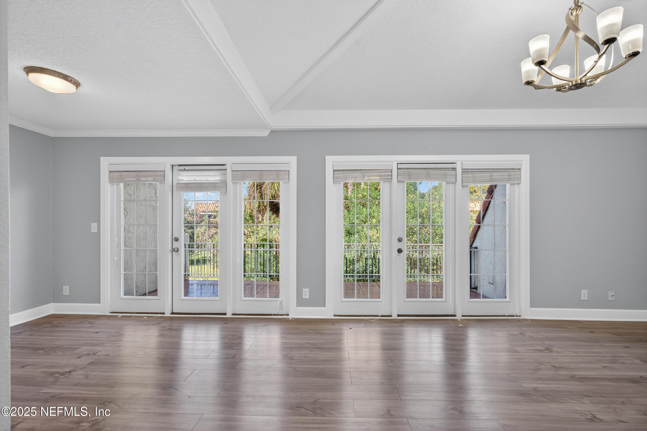 3913 Mission Drive, Unit 4 Jacksonville, FL 32217 - Photo 3 of 26 an empty room with wooden floor and windows