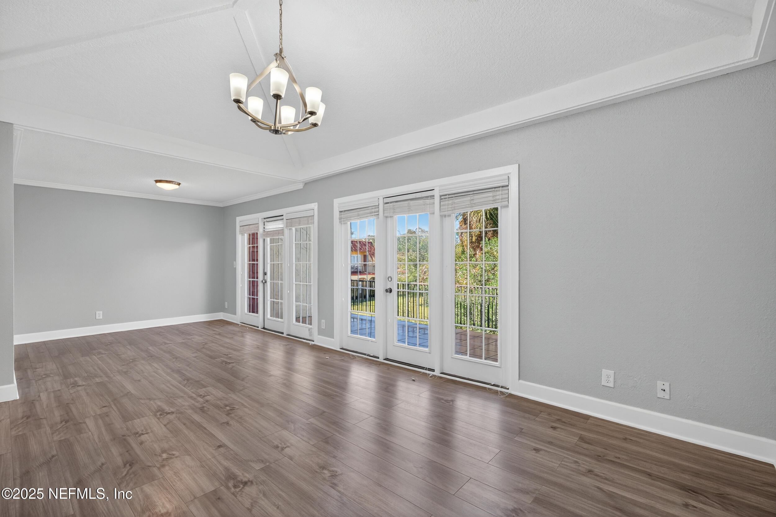 3913 Mission Drive, Unit 4 Jacksonville, FL 32217 - Photo 4 of 26 a view of an empty room with wooden floor and a window