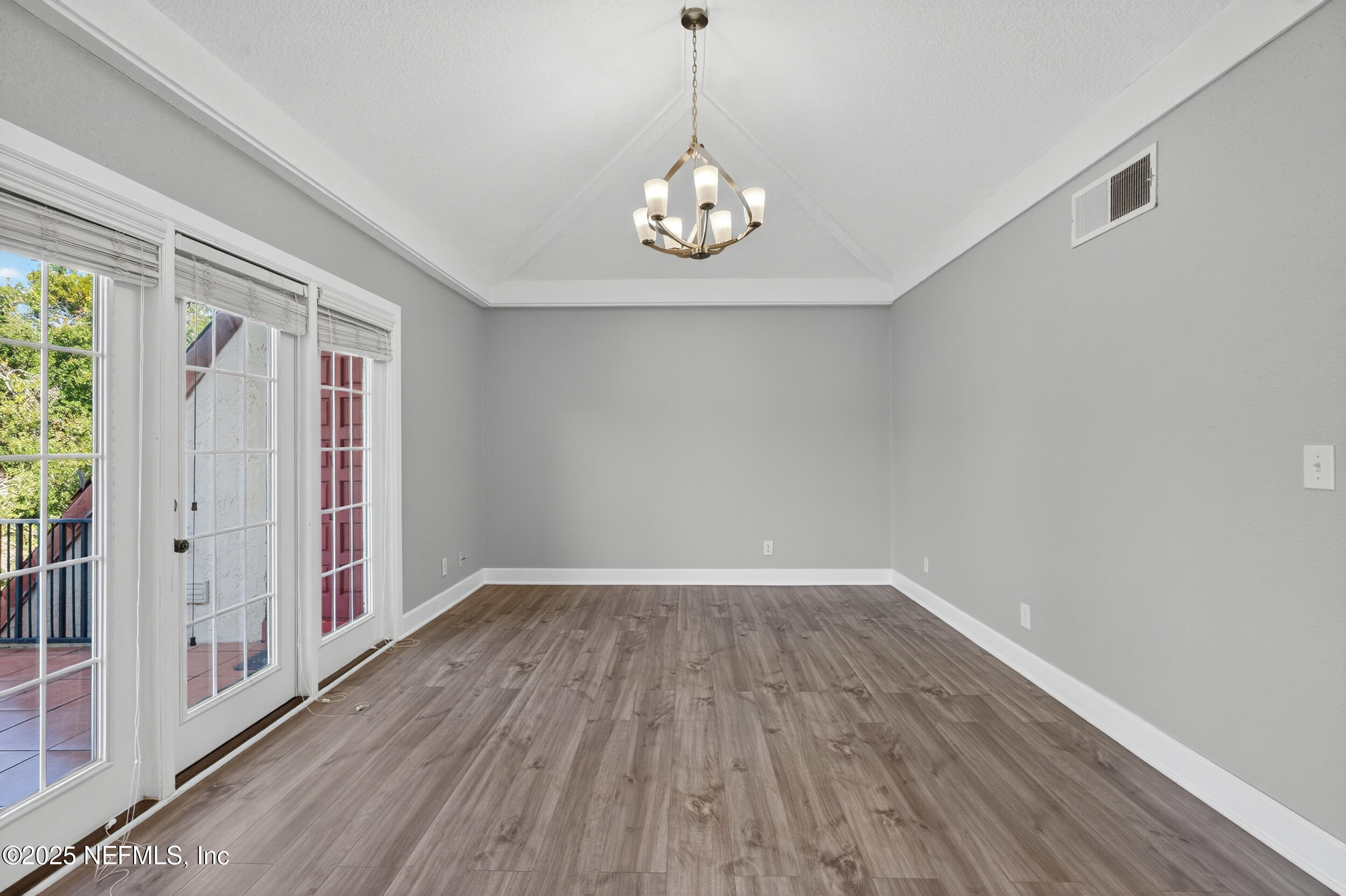 3913 Mission Drive, Unit 4 Jacksonville, FL 32217 - Photo 5 of 26 a view of an empty room with wooden floor and a window