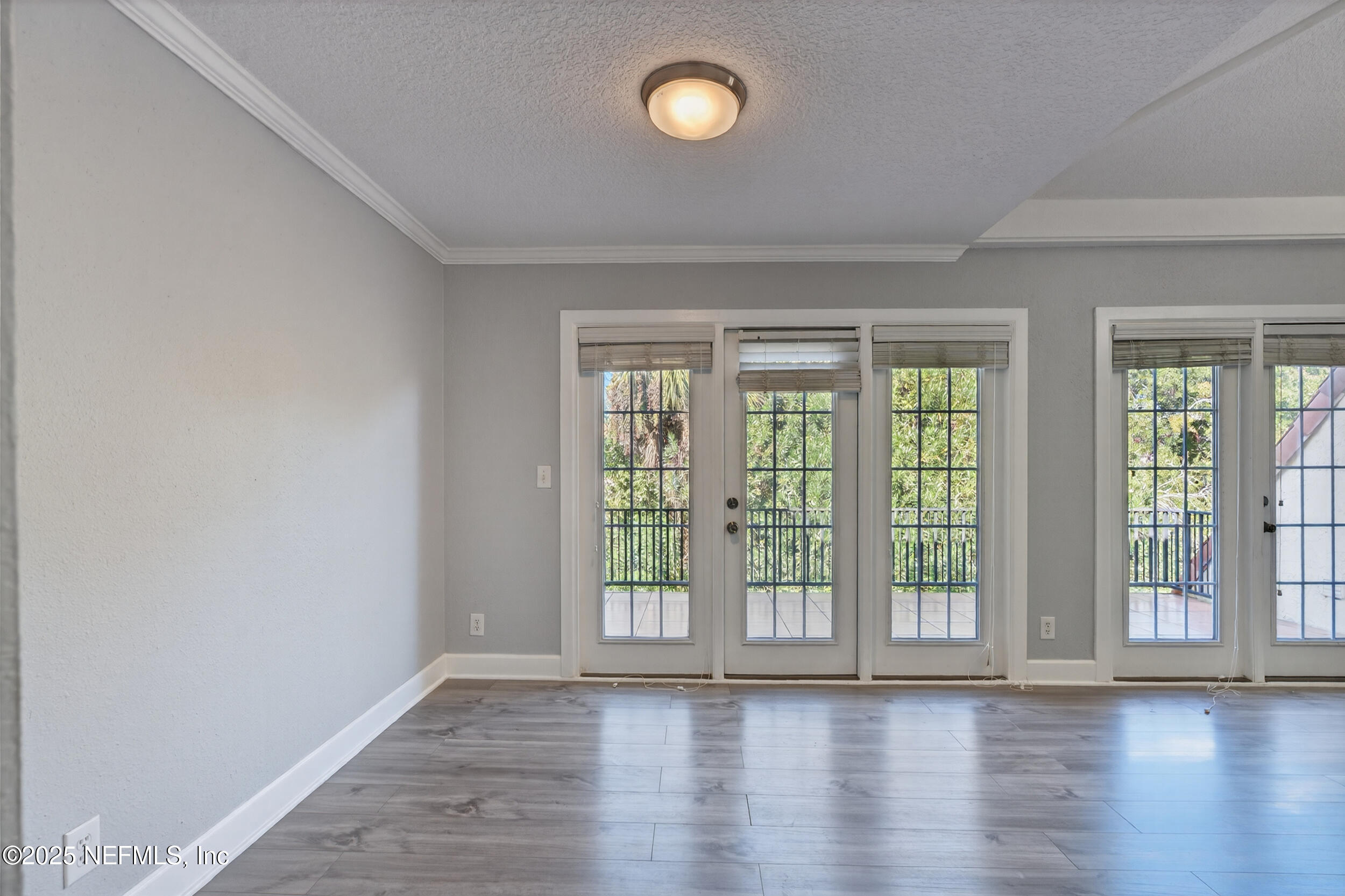 3913 Mission Drive, Unit 4 Jacksonville, FL 32217 - Photo 6 of 26 a view of an empty room with wooden floor and fan