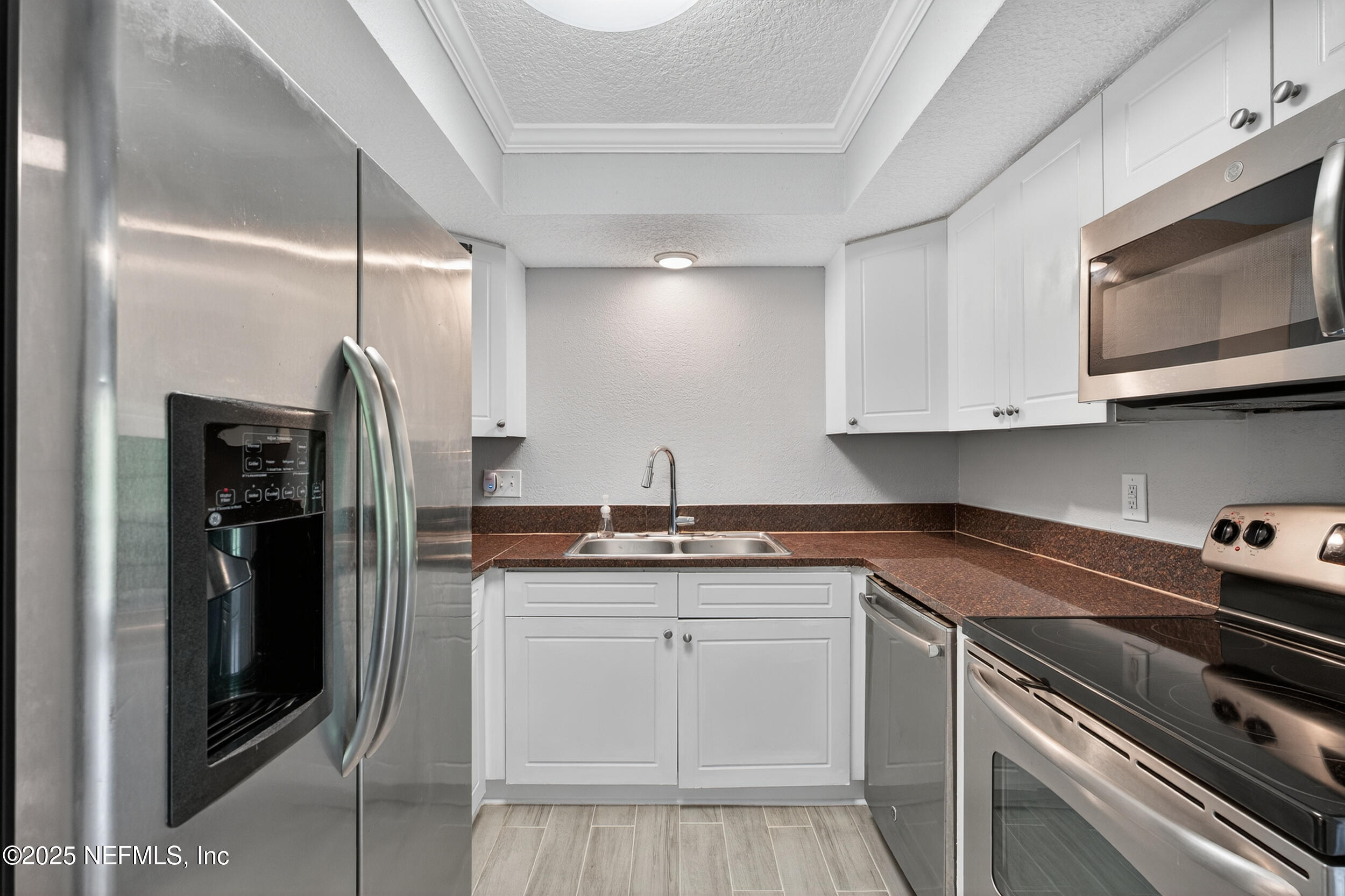 3913 Mission Drive, Unit 4 Jacksonville, FL 32217 - Photo 8 of 26 a kitchen with stainless steel appliances granite countertop a sink and a stove