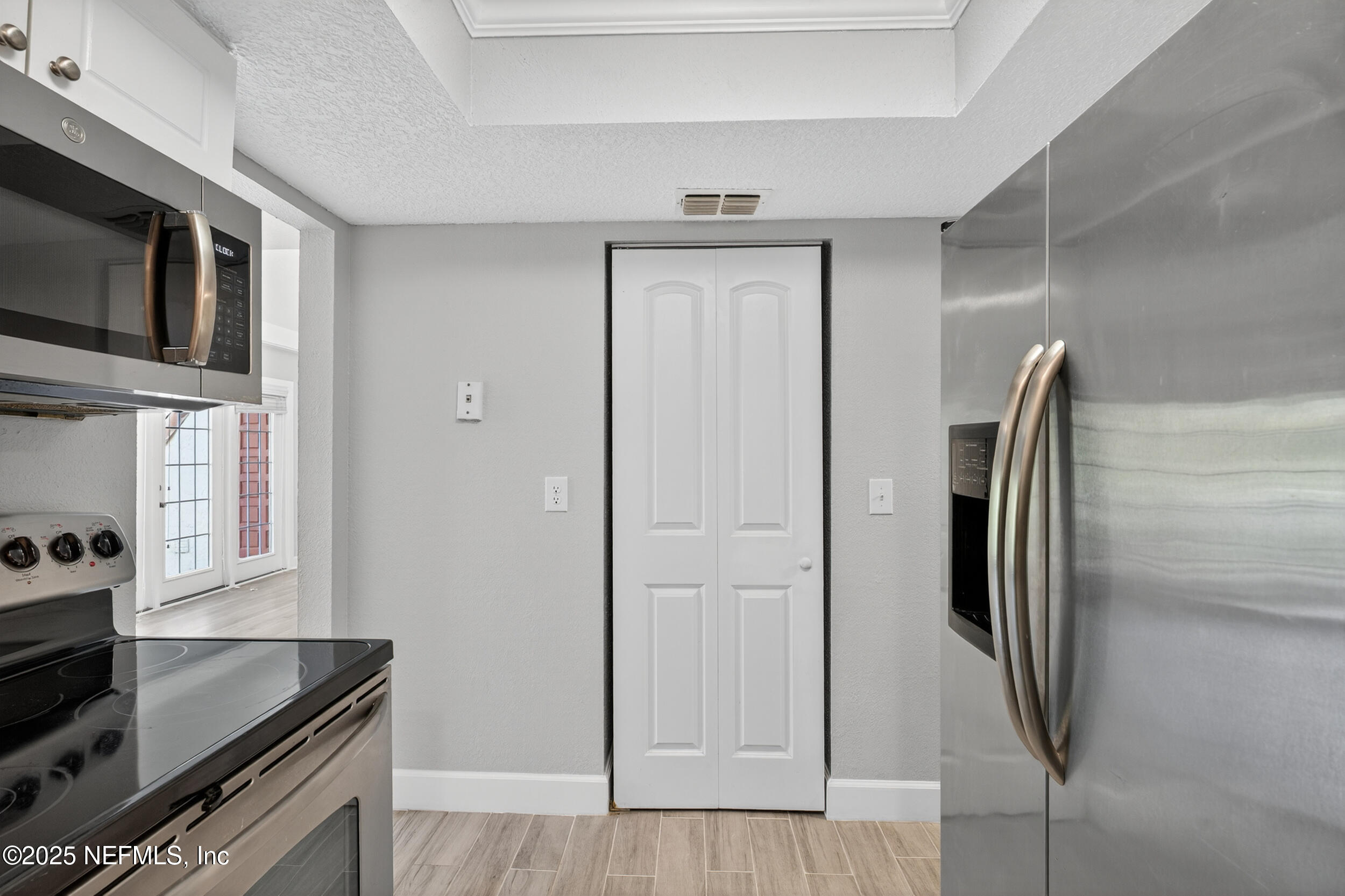 3913 Mission Drive, Unit 4 Jacksonville, FL 32217 - Photo 9 of 26 a kitchen with stainless steel appliances granite countertop a refrigerator and a stove top oven