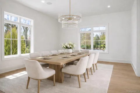 a dining room with furniture a chandelier and wooden floor