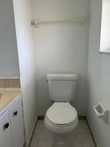 a bathroom with a toilet and a bath tub