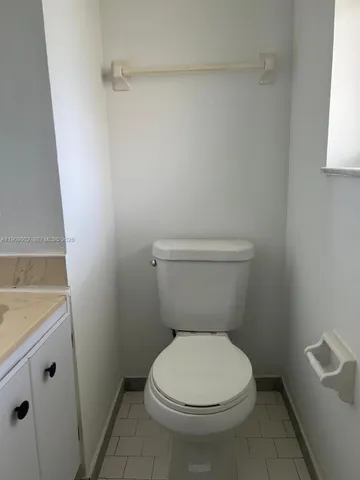 a white toilet sitting next to a sink